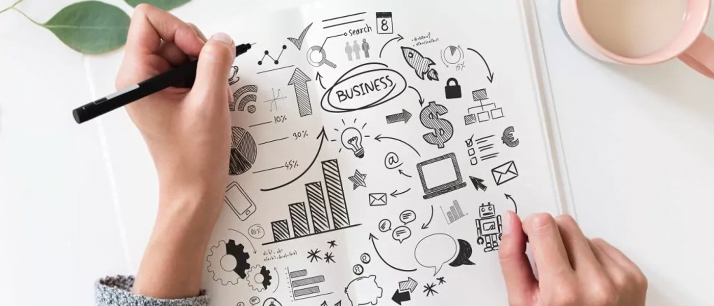 person drawing on notepad