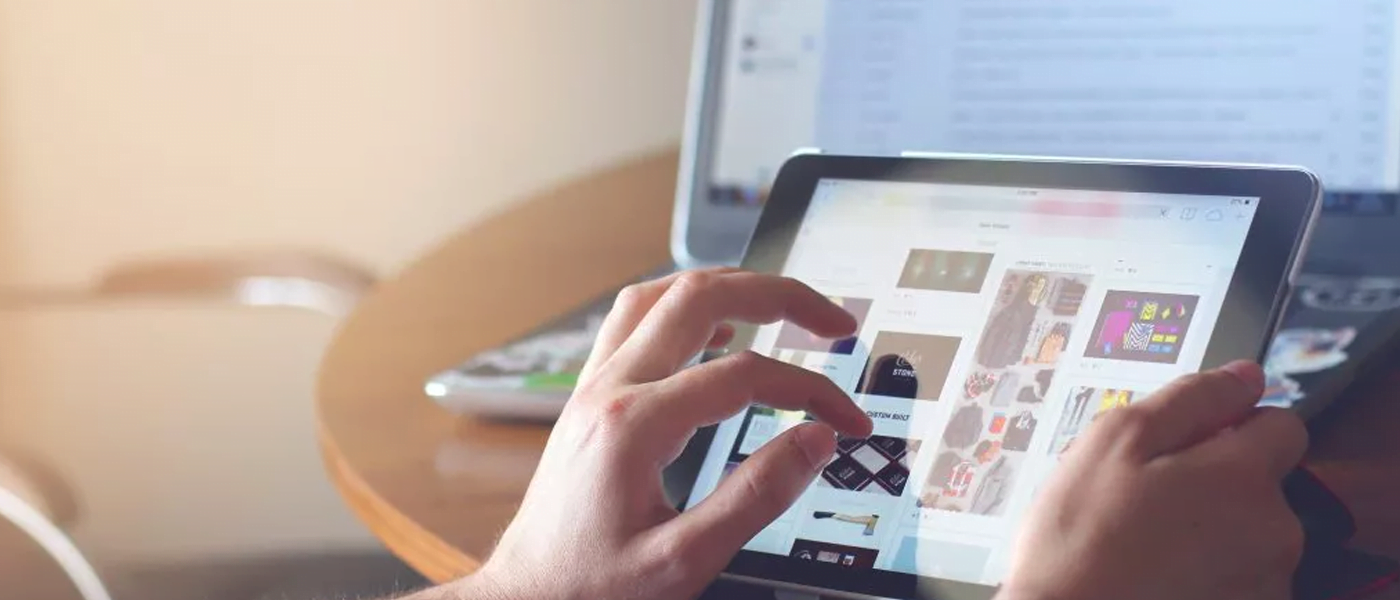 person using tablet and laptop