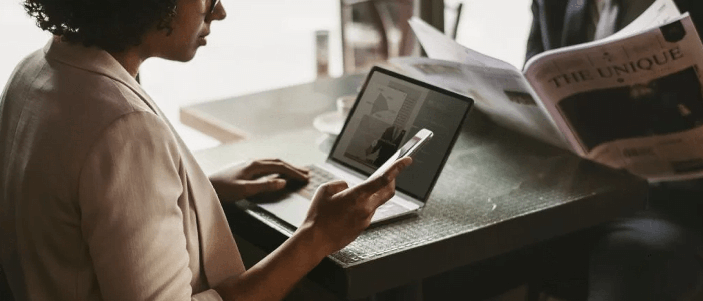 woman using macbook and phone