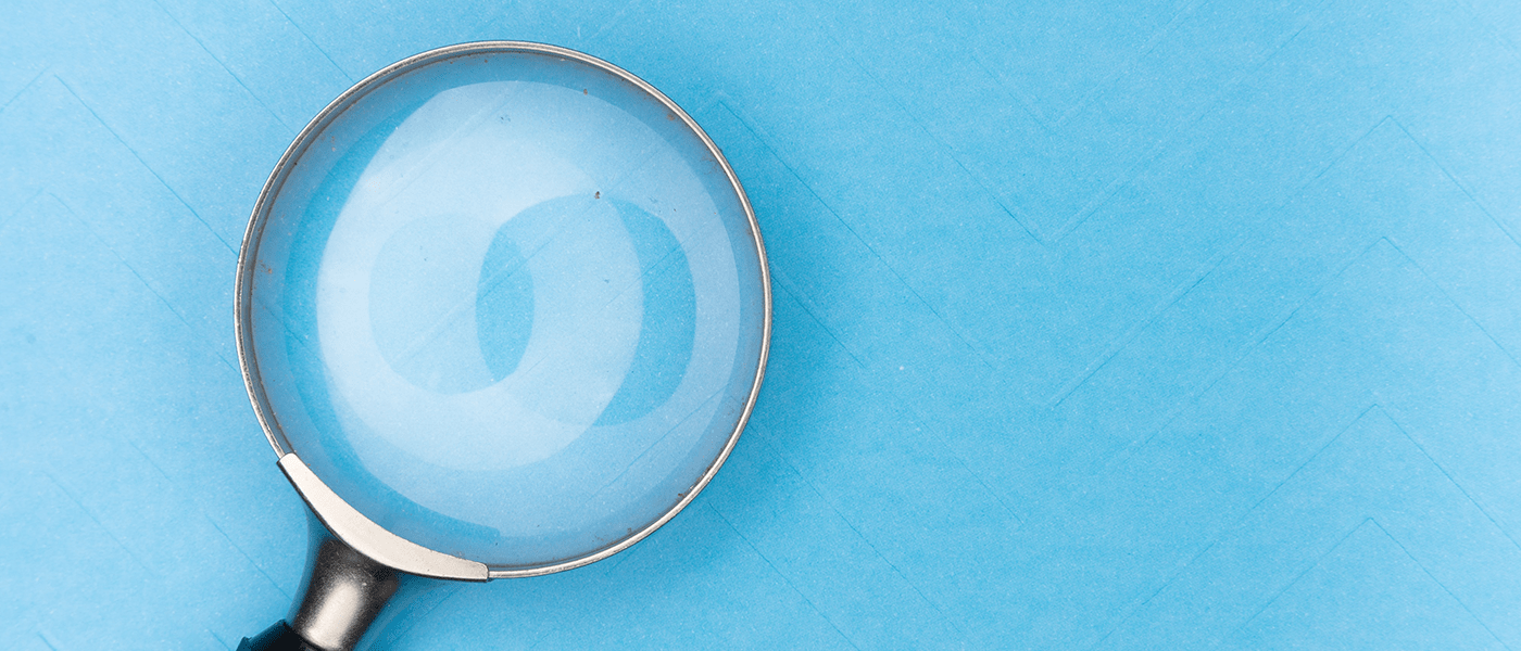 Magnifying glass against blue background