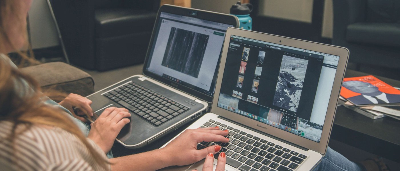 Two people using laptops
