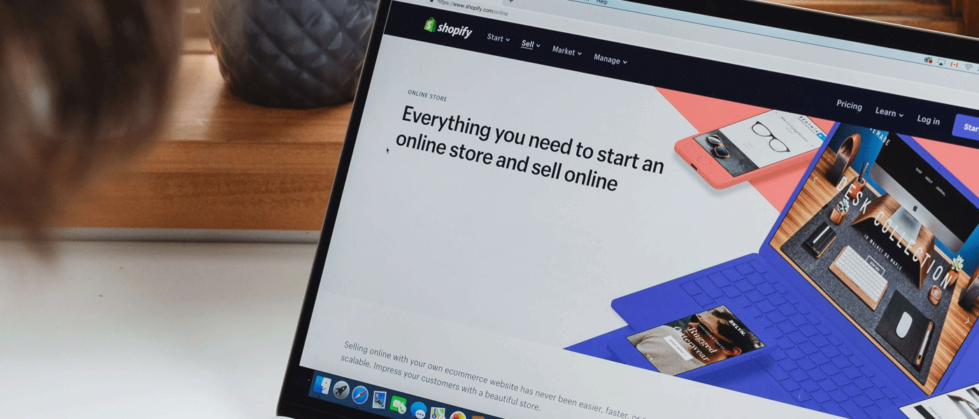 person on shopify homepage on laptop
