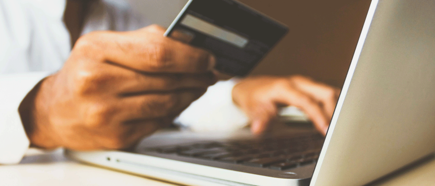 person using card to make payment online