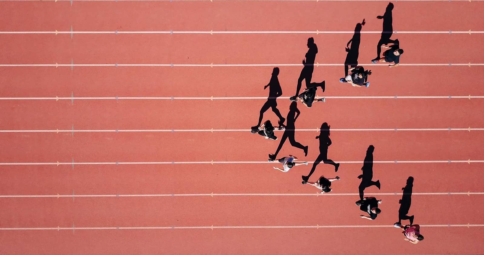 Aerial view of people running on a track - fitness and exercise in action