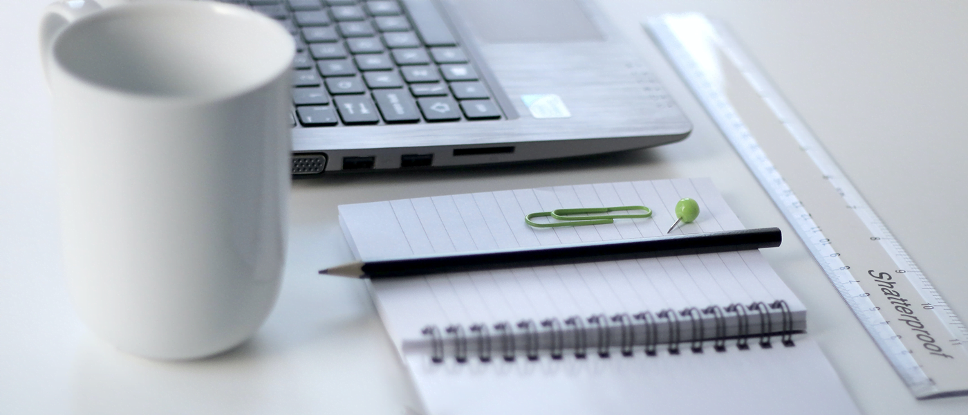 Desk with laptop and notepad