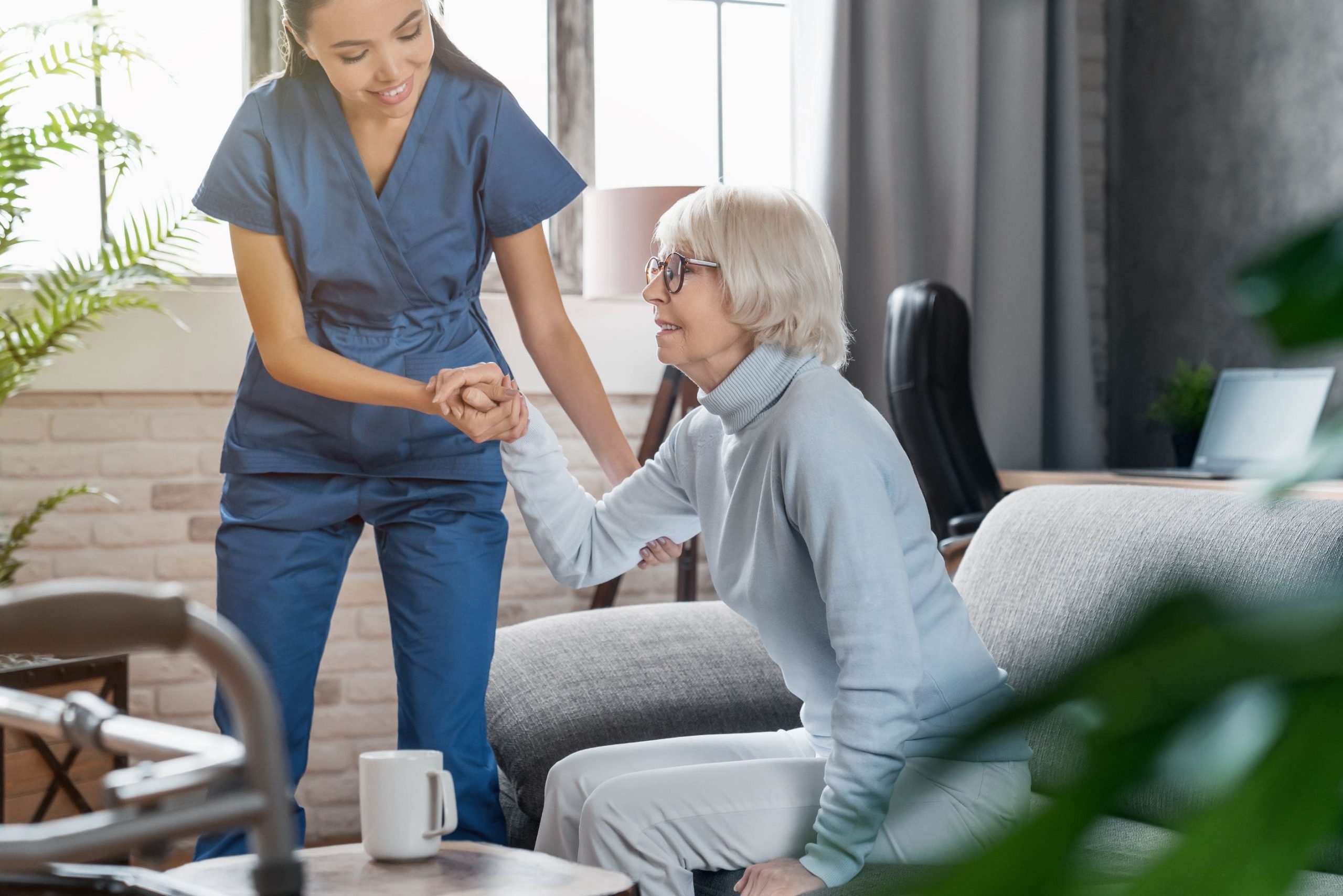 Professional caregiver taking care of elderly woman at home